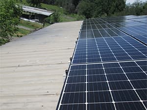 Solar Panels on Barn Roof Large solar panel system installed on barn or warehouse roof for energy generation