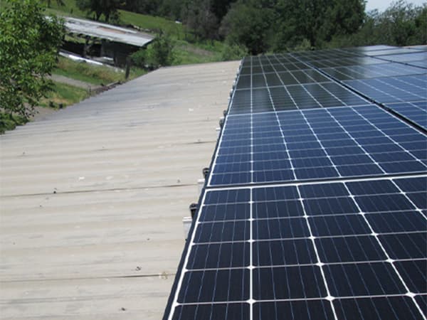 Solar Panels on Barn Roof Large solar panel system installed on barn or warehouse roof for energy generation