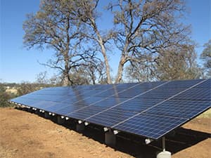 Off-Grid Solar Panel System Large solar panel system installed on rural hillside for off grid power