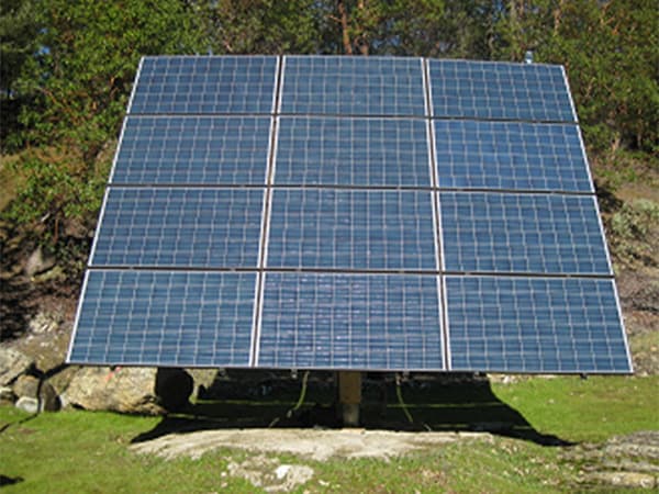Off-Grid Solar Panel System Large solar panel system installed on rural hillside for off grid power