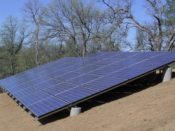 Community Solar Panels Solar panel installation on hillside providing shared community solar energy