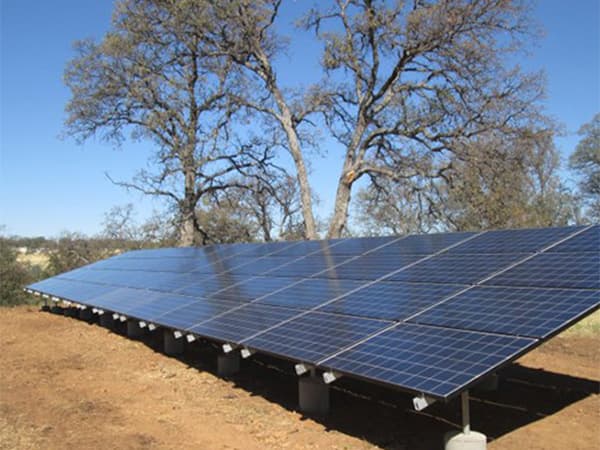 Off-Grid Solar Panel System Large solar panel system installed on rural hillside for off grid power